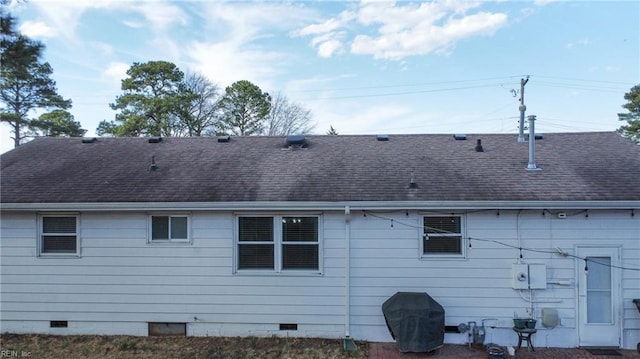 rear view of house with crawl space and roof with shingles