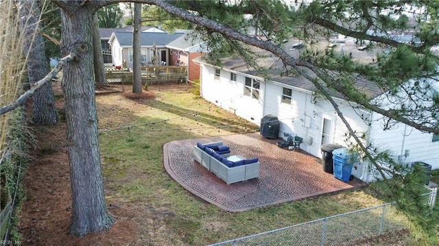 view of storm shelter featuring a patio, a lawn, and fence