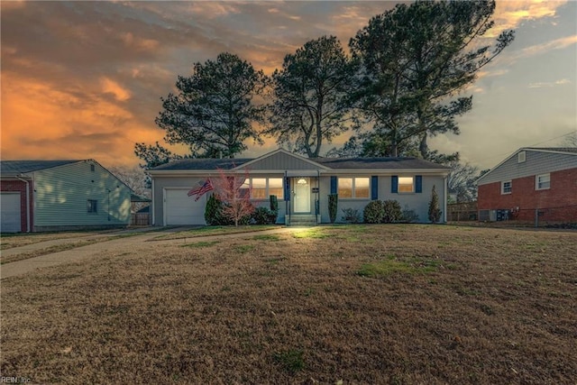 single story home with an attached garage, fence, a front lawn, and concrete driveway