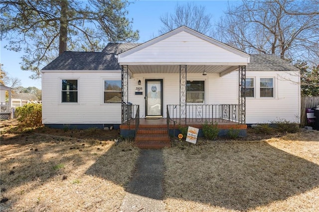 view of front of property with covered porch and a shingled roof