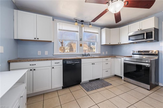 kitchen with a sink, light tile patterned flooring, white cabinetry, and stainless steel appliances