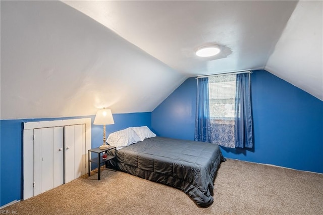 carpeted bedroom with vaulted ceiling