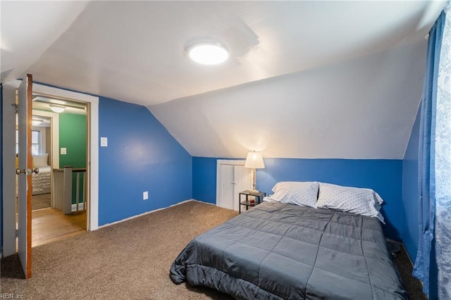 bedroom with lofted ceiling and carpet