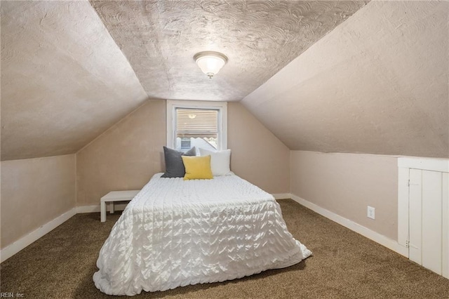 carpeted bedroom with baseboards, a textured ceiling, and lofted ceiling