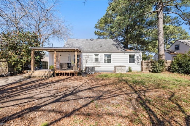 back of house with a wooden deck and fence