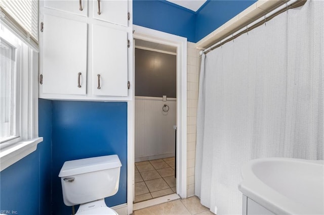 full bathroom with tile patterned floors, curtained shower, and toilet