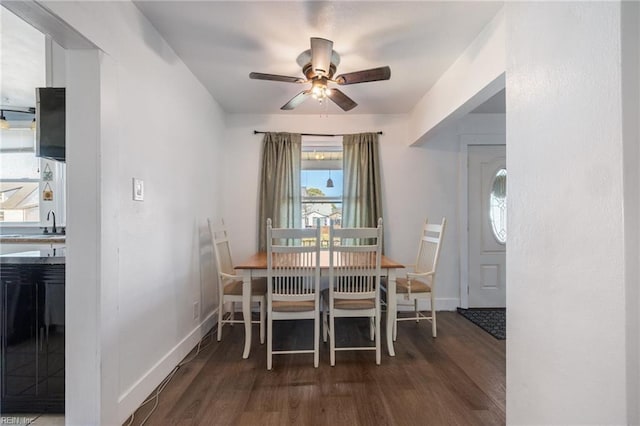 dining room featuring a ceiling fan, wood finished floors, and baseboards