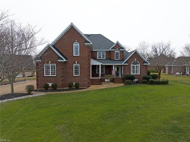 view of front of property featuring brick siding and a front yard