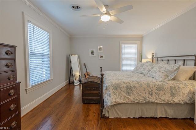 bedroom featuring baseboards, crown molding, visible vents, and wood finished floors