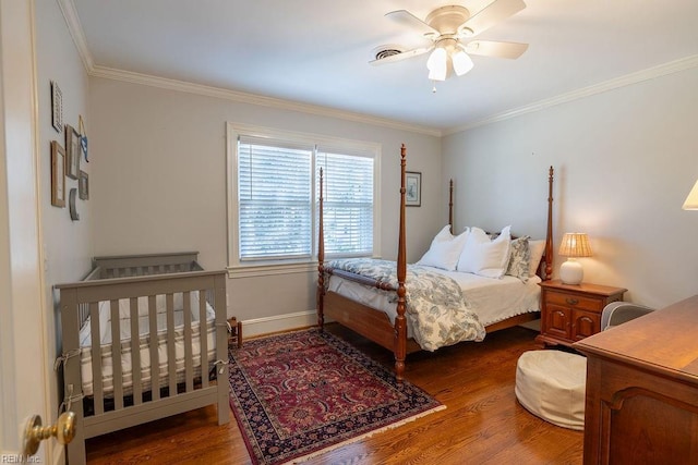 bedroom featuring ornamental molding, wood finished floors, a ceiling fan, and baseboards