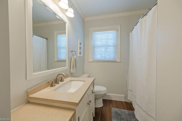 full bathroom with baseboards, toilet, ornamental molding, wood finished floors, and vanity