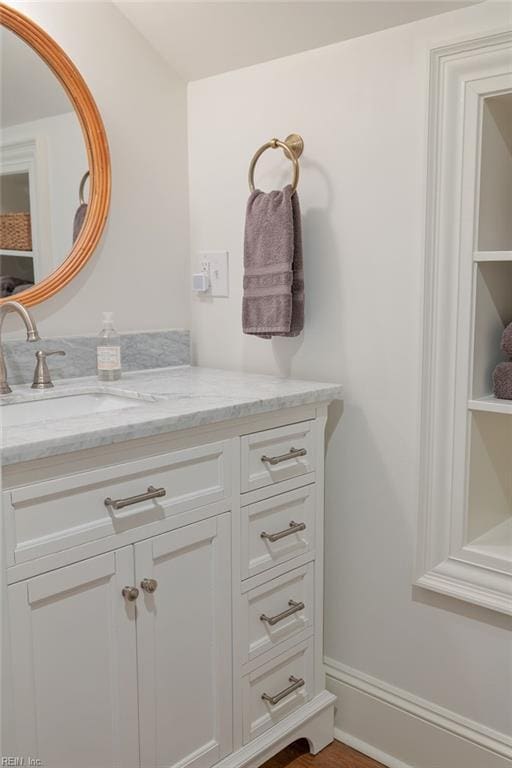 bathroom with baseboards and vanity