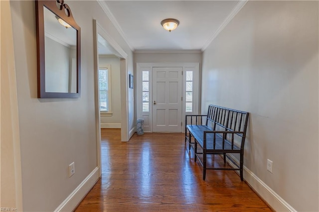 foyer entrance with ornamental molding, wood finished floors, and baseboards