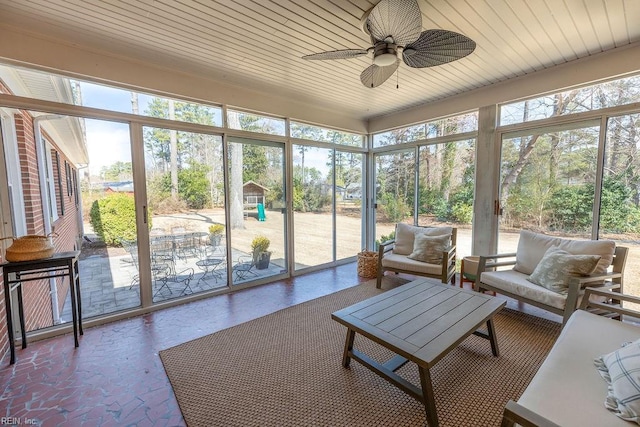 sunroom featuring wood ceiling and ceiling fan