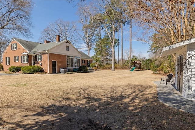 view of yard featuring central AC and a playground