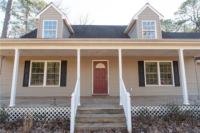 property entrance with a shingled roof and covered porch