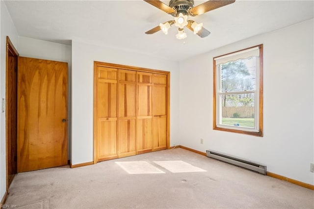 unfurnished bedroom featuring baseboards, carpet flooring, a closet, a ceiling fan, and a baseboard radiator