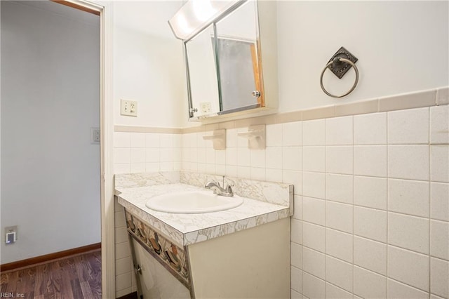 bathroom with wainscoting, tile walls, vanity, and wood finished floors