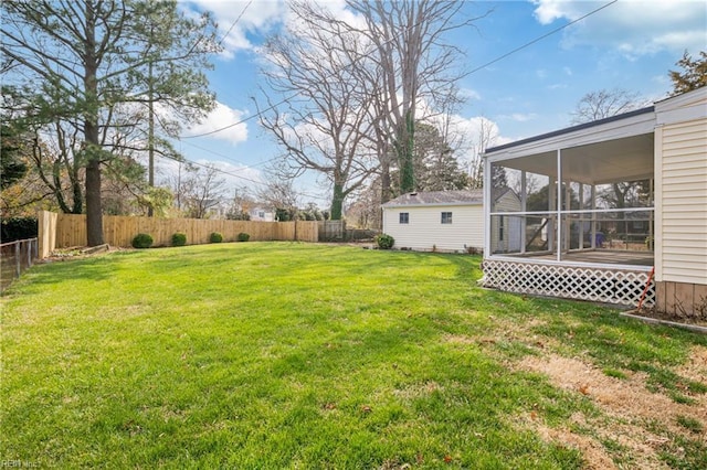 view of yard featuring a fenced backyard and a sunroom