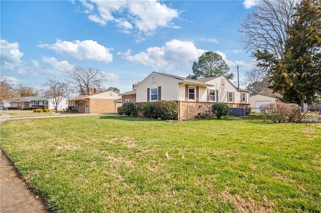 ranch-style house with brick siding, a front lawn, and fence