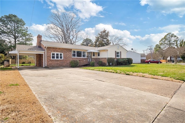 single story home featuring an attached carport, concrete driveway, a front yard, brick siding, and a chimney