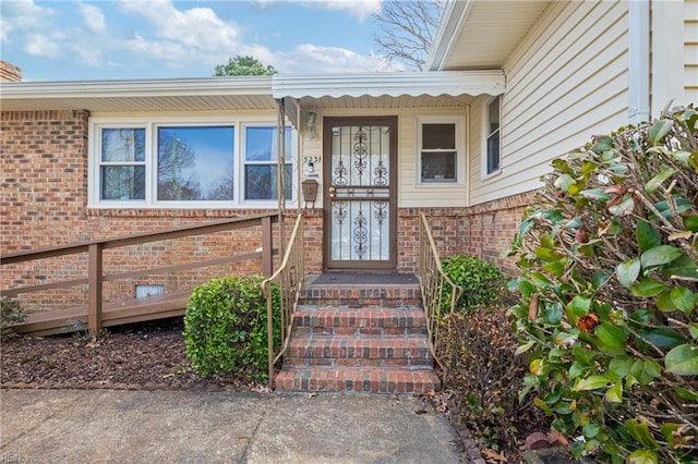 property entrance with brick siding