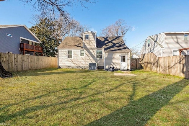 rear view of house featuring crawl space, central AC unit, a lawn, and a fenced backyard