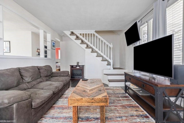 living room featuring stairway