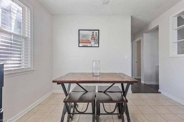 dining room with light tile patterned flooring and baseboards