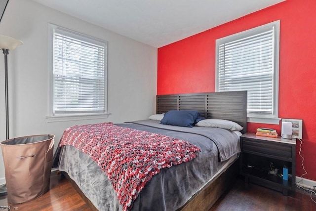 bedroom featuring baseboards and wood finished floors