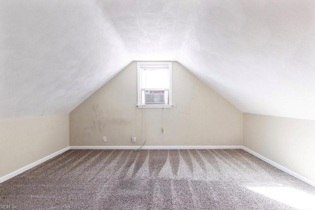 bonus room with vaulted ceiling, carpet floors, and baseboards