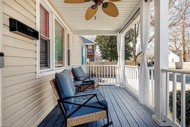 deck featuring covered porch and a ceiling fan