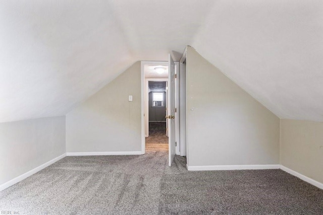 bonus room featuring carpet, baseboards, and vaulted ceiling