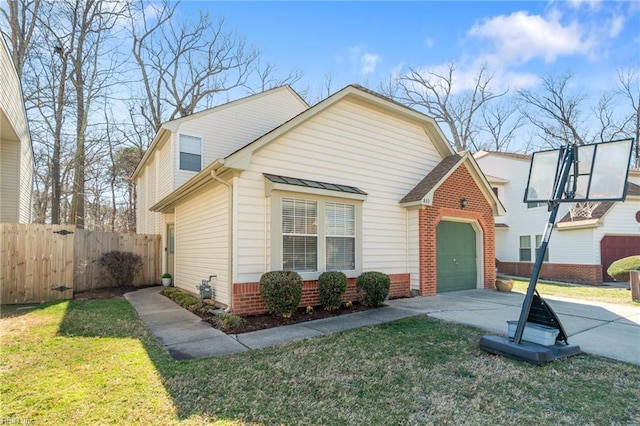 view of front facade with a garage, brick siding, fence, concrete driveway, and a front lawn