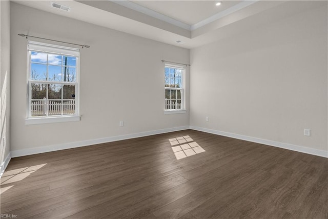 unfurnished room with recessed lighting, dark wood finished floors, visible vents, and baseboards