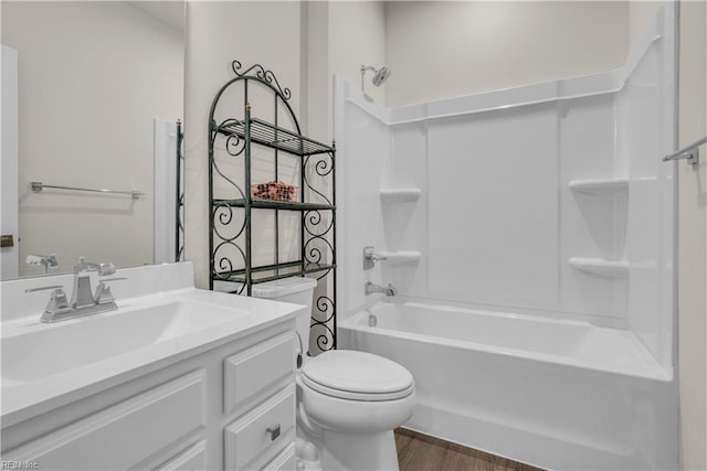 full bath with vanity, tub / shower combination, wood finished floors, and toilet