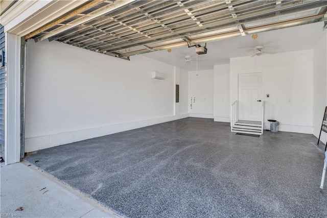 garage with a garage door opener and electric panel