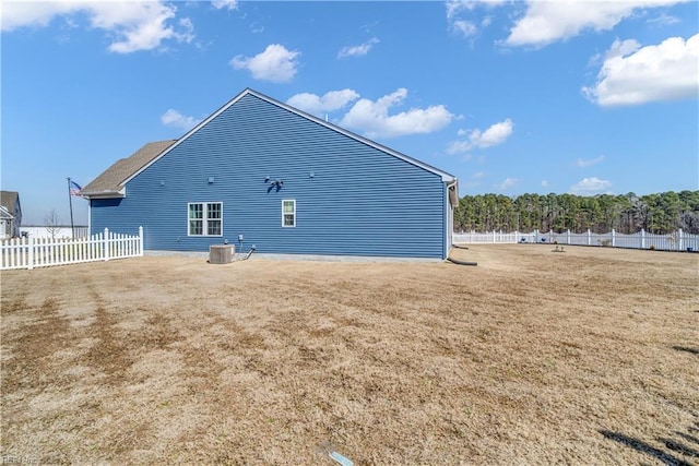 back of house with central AC unit and fence