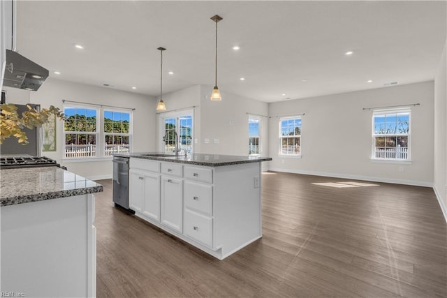 kitchen featuring recessed lighting, white cabinetry, a sink, dark stone countertops, and extractor fan