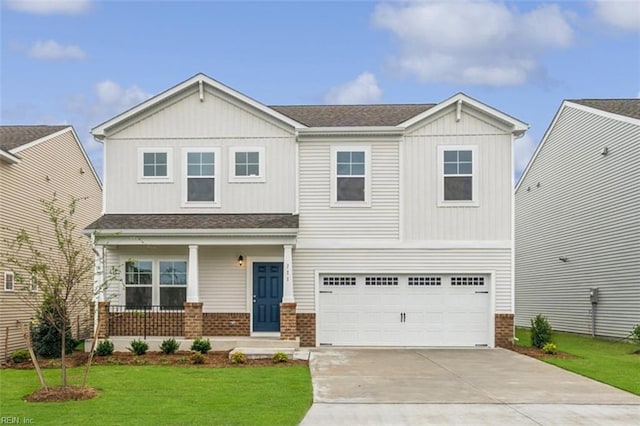 craftsman-style home featuring covered porch, a garage, brick siding, driveway, and a front lawn