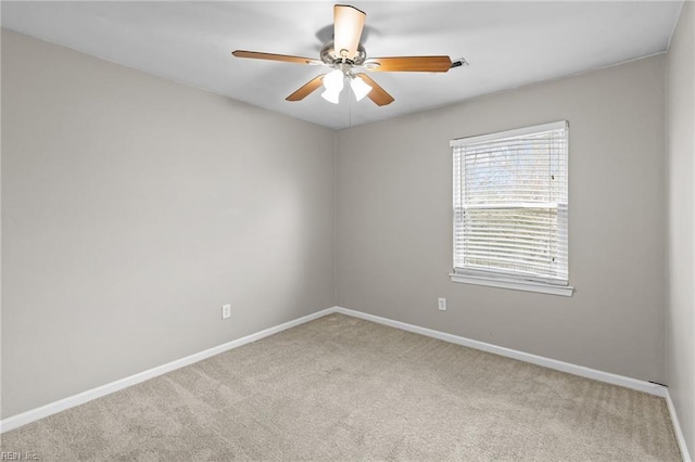 spare room featuring baseboards, carpet floors, and ceiling fan