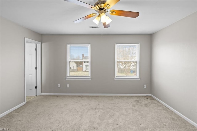 spare room featuring visible vents, a ceiling fan, baseboards, and carpet floors