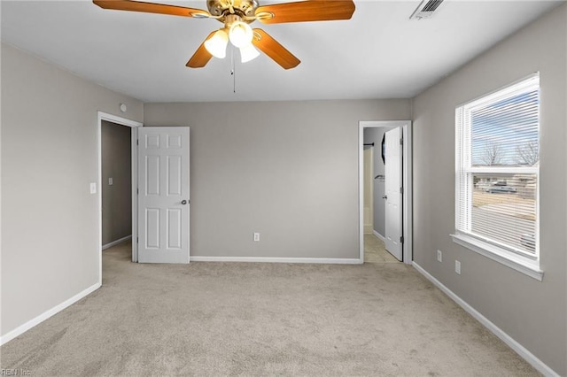 unfurnished bedroom with visible vents, connected bathroom, baseboards, ceiling fan, and carpet flooring