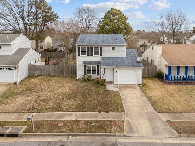 traditional home featuring fence, driveway, a front lawn, a garage, and a residential view