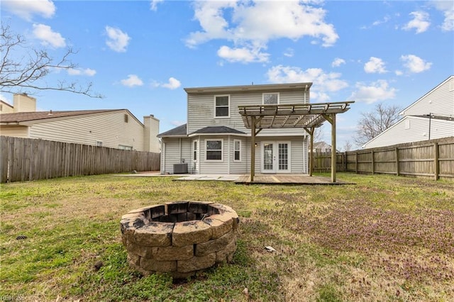 rear view of property with a yard, french doors, a pergola, and a fenced backyard