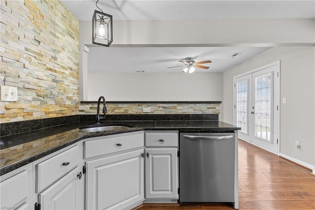 kitchen featuring a sink, white cabinets, dark wood-type flooring, and stainless steel dishwasher