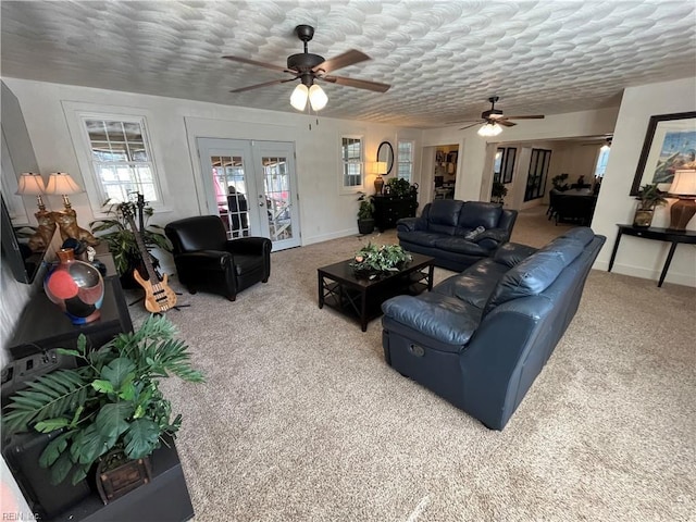 living room with french doors, carpet flooring, a textured ceiling, and baseboards