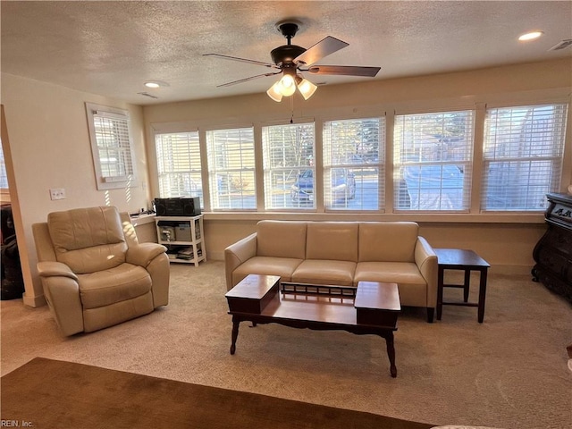 carpeted living room featuring a ceiling fan, recessed lighting, and a textured ceiling