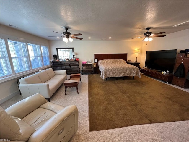 carpeted bedroom with a textured ceiling, ceiling fan, recessed lighting, visible vents, and baseboards