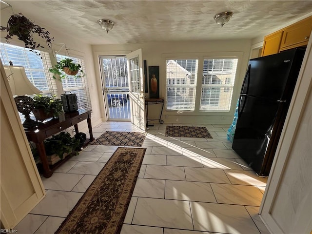 entryway featuring a textured ceiling